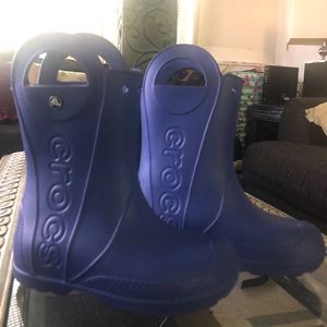 Crocs rain boots.